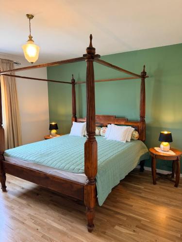 a bedroom with a canopy bed with two lamps at Zimmer Room Trogir Kastela Split in Kaštela