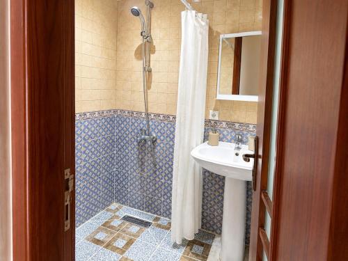 a bathroom with a shower and a sink at Beachside Garden Apartment in Marina Smir in Marina Smir