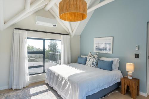 a bedroom with a bed and a large window at Eden on Walton 1 in Sea Vista