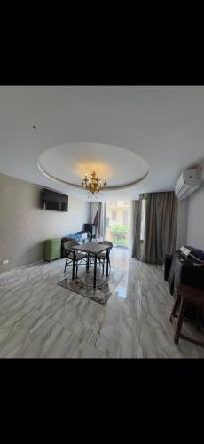 a living room with a table and a couch at Osiris Cairo Hotel Downtown in Cairo