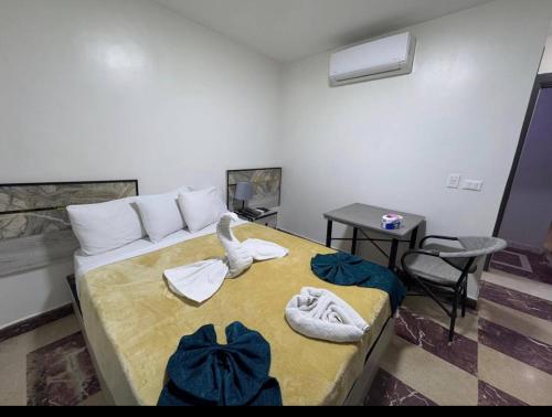 a bedroom with a bed with towels on it at Osiris Cairo Hotel Downtown in Cairo