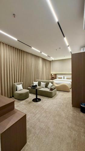 a living room with two couches and a table in it at فندق شفت جازان Shift Jizan Hotel in Jazan