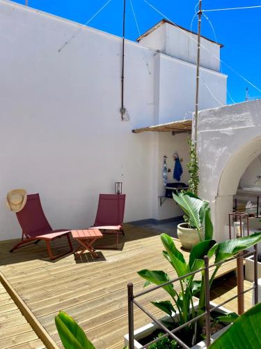 a patio with two chairs and a table at Amare Gallipoli in Gallipoli