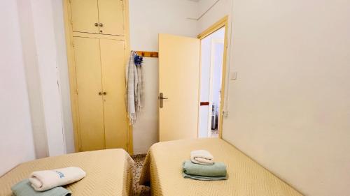 a bedroom with two beds and a mirror at Todimer Acera del Mar in Torrenueva