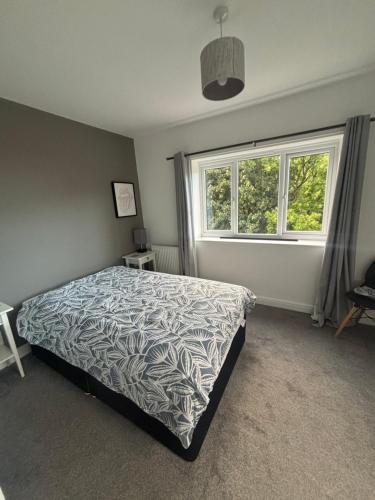a bedroom with a bed and a window at Nirvana house in Deepcar
