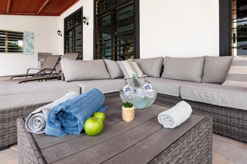 a living room with a couch and apples on a table at Private Pool, Beach Access 3BR Sleeps 6 in Chelem