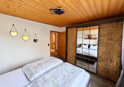 a bedroom with a bed and a ceiling at Ferienwohnung Maxi in Pottenstein
