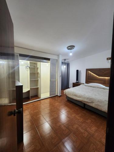 a bedroom with a bed and a sliding glass door at Trajineras xochimilco in Mexico City