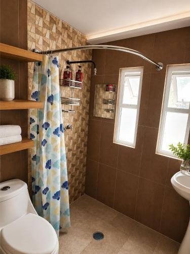 a bathroom with a shower curtain and a toilet at Trajineras xochimilco in Mexico City