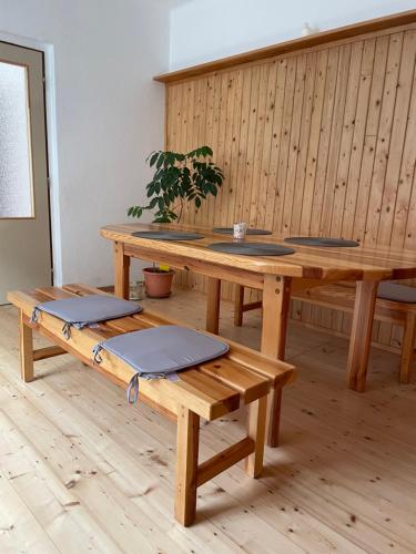 a large wooden table with benches in a room at Leon in Lomnice nad Lužnicí