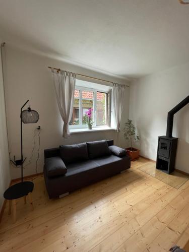 a living room with a couch and a window at Leon in Lomnice nad Lužnicí