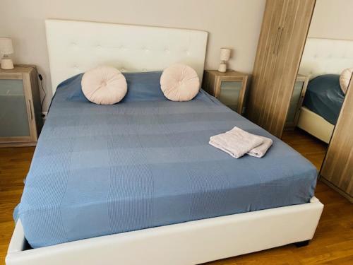 a bedroom with a bed with two pillows on it at Blue Riviera in Roquebrune-Cap-Martin