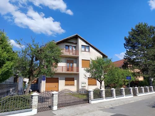 a white house with a fence in front of it at Appartement UNA La Bella 3* in Bihać