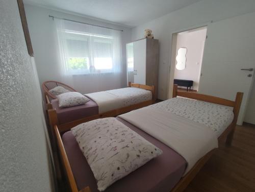 a bedroom with two beds and a window at Apartman Dream in Livno