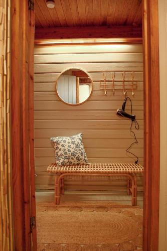 a mirror and a bench in a room at Gnista Glamping in Fäboda