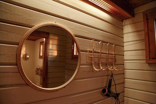 a mirror on the wall of a bathroom at Gnista Glamping in Fäboda