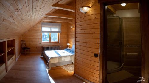 a bedroom with a bed and a shower in a room at Amoliņi in Mērsrags