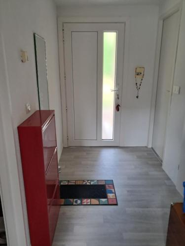 an empty room with a door and a wooden floor at La Châtelaine in Lombez