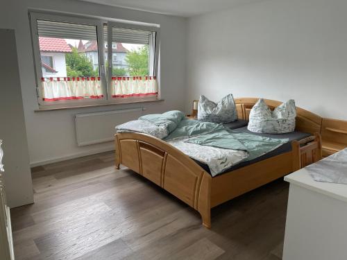 a bed sitting in a room with a window at Monteur-Ferienwohnung Julianna in Bad Staffelstein in Bad Staffelstein