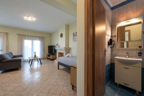 a hotel room with a sink and a bedroom at Anima Horizon - Terra apartment in Elaiófiton