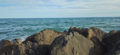 a group of rocks on the ocean near the water at Entre Ciel&Mer in Palavas-les-Flots