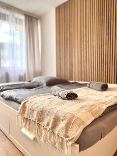 a bed with two pillows on it in a bedroom at Adriany apartmán in Bayerisch Eisenstein