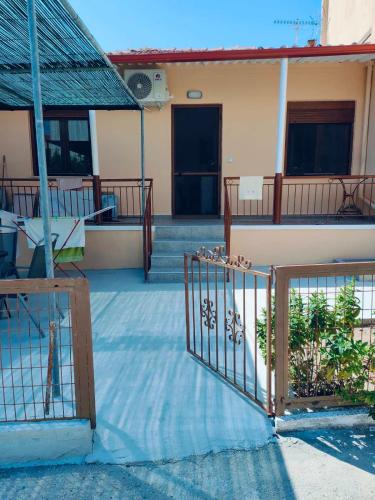 a building with a gate in front of a building at Barefoot Nest in Nea Skioni