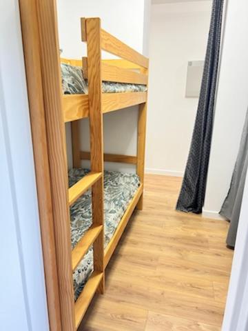 a wooden book shelf in a room at appartement T2 climatisé proche centre et plage in Cavalaire-sur-Mer