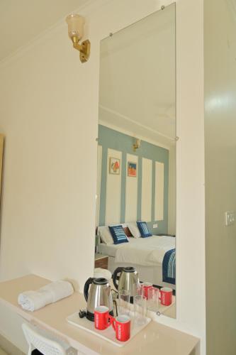 a bedroom with a bed and a mirror at shangrila stay in Bodh Gaya