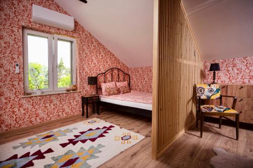 a small room with a bed and a window at Dom pod Niebem in Lucimia