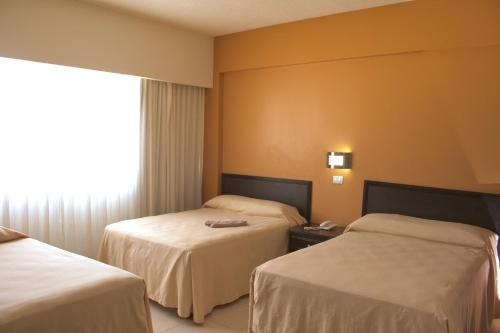 Säng eller sängar i ett rum på Hotel Miraflores Villahermosa