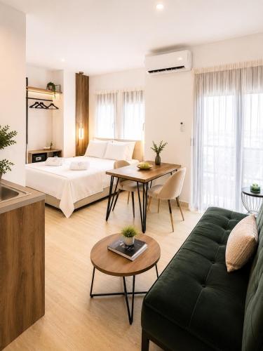 a living room with a bed and a table at ATHONITE all seasons luxury suites in Ierissos