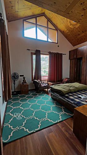 a bedroom with a bed and a green rug at Falak Stays in Shamshi