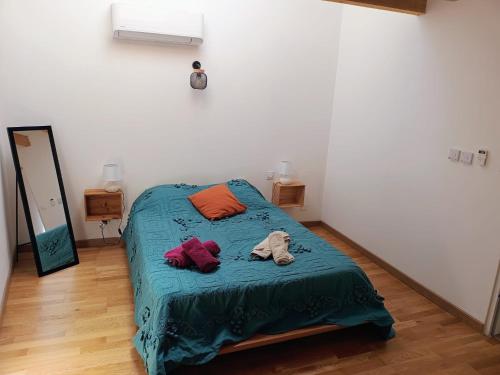a bedroom with a bed with a teddy bear on it at Chez Audrey in Courthézon