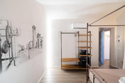 a room with a staircase and drawings on the wall at Chioggia Rooms in Chioggia