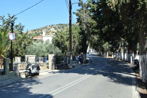 a street with a motorcycle parked on the side of the road at Το περασμα in Panormos Kalymnos
