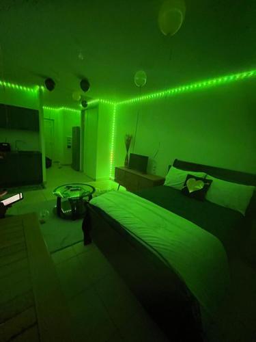 ein grünes Zimmer mit einem Bett mit grünem Licht in der Unterkunft Waterfront in Saint Martin