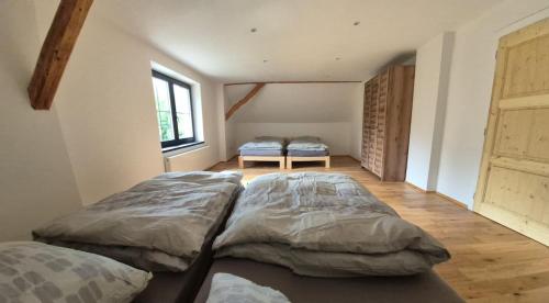 two large beds in a room with a window at House by the water in Lesík