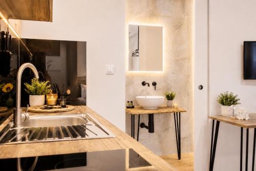 a kitchen with a sink and a mirror at ATHONITE all seasons luxury suites in Ierissos