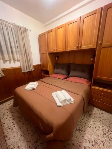 a bedroom with a bed with two towels on it at Sangro River Casa Vacanza in Castel di Sangro