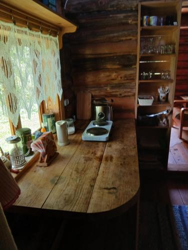 a kitchen with a wooden counter top in a cabin at Pähnamäe metsamajake in Ruusmäe