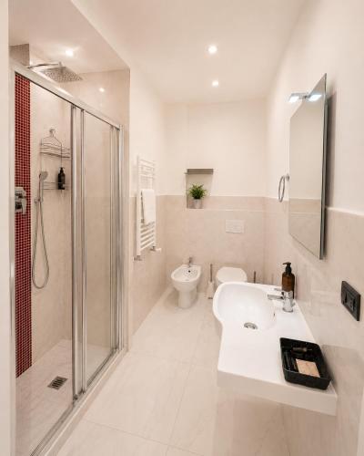 a bathroom with a sink and a shower and a toilet at Hotel Luxor Florence in Florence