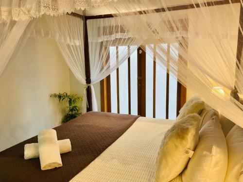a bedroom with a bed with a window at Gedara Boutique in Katunayaka