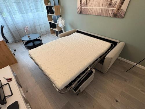 a hospital bed in a room with a table at Le cocon de la Citadelle in Chalon-sur-Saône