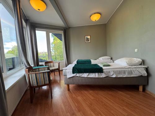 a bedroom with a bed and a large window at I&A Residence Humala in Tallinn