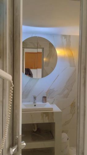 a bathroom with a sink and a mirror at Villa Rena in Batsi