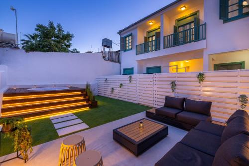 a patio with a couch and a table in front of a building at Pageant Homes in Nicosia