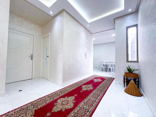 an empty room with a red rug and a door at Apartment in Azemmour in Azemmour
