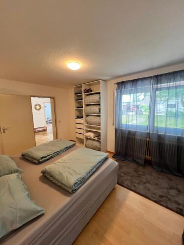 a bedroom with two beds and a large window at Modern Living - Tuttlingen in Tuttlingen