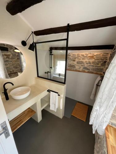 a bathroom with a sink and a mirror at Gîte de Calouze - 5 personnes in Gijounet